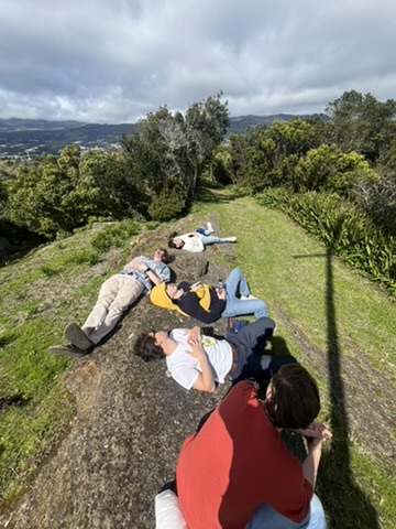 Students relaxing outdoors on a hillside