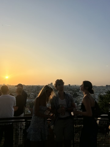 Students at sunset overlooking city